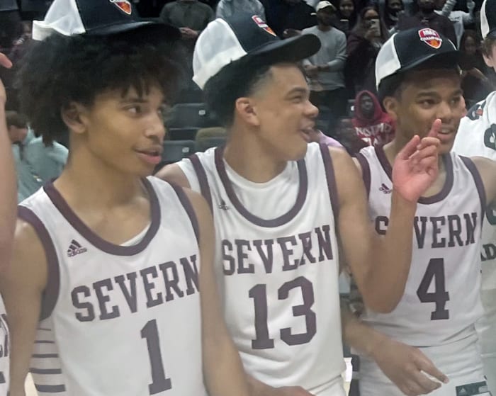 Severn's Corey Dixon (13) shares a laugh with teammates Daniel Growney (left) and Kinston Price after Saturday's MIAA B Conference championship game Saturday at UMBC. Dixon, the son of former Maryland All-American and NBA player Juan Dixon, played a major role this season as a freshman for the Admirals who won their first title in 31 years.